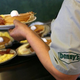 Denny's server holding plates of breakfast food